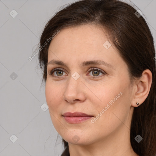 Joyful white adult female with medium  brown hair and brown eyes