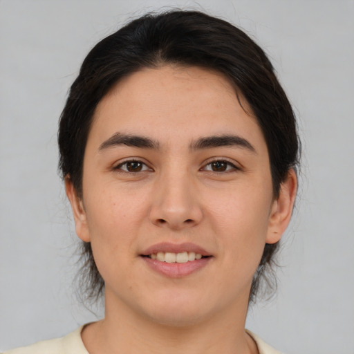 Joyful white young-adult female with medium  brown hair and brown eyes