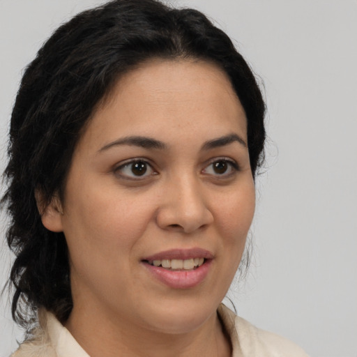 Joyful latino young-adult female with medium  brown hair and brown eyes