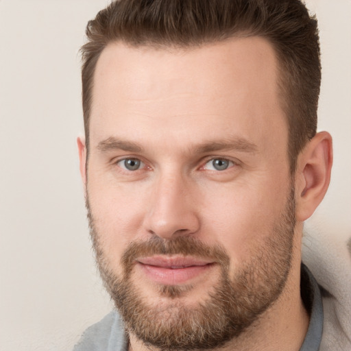 Joyful white adult male with short  brown hair and brown eyes