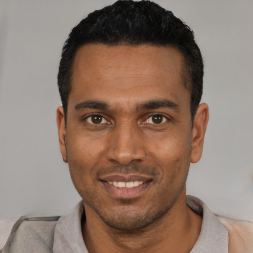 Joyful white young-adult male with short  black hair and brown eyes