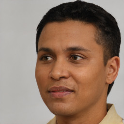 Joyful latino young-adult male with short  black hair and brown eyes