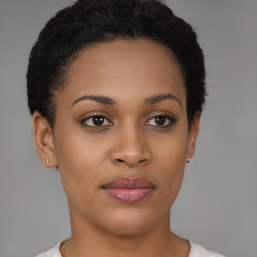 Joyful black young-adult female with short  black hair and brown eyes