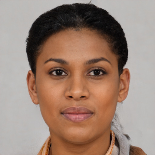 Joyful black young-adult female with short  black hair and brown eyes