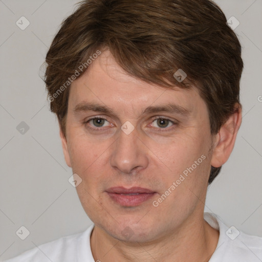 Joyful white adult male with short  brown hair and grey eyes