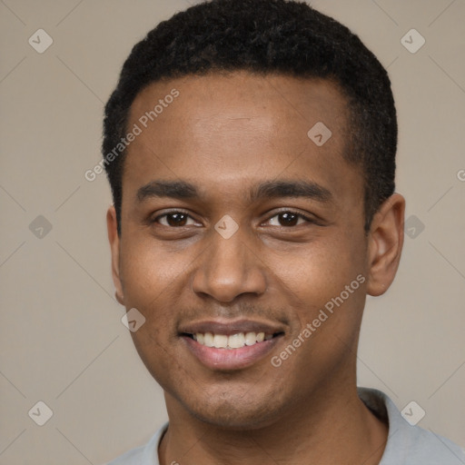 Joyful black young-adult male with short  black hair and brown eyes