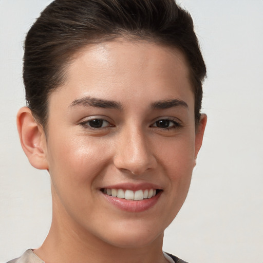 Joyful white young-adult female with short  brown hair and brown eyes