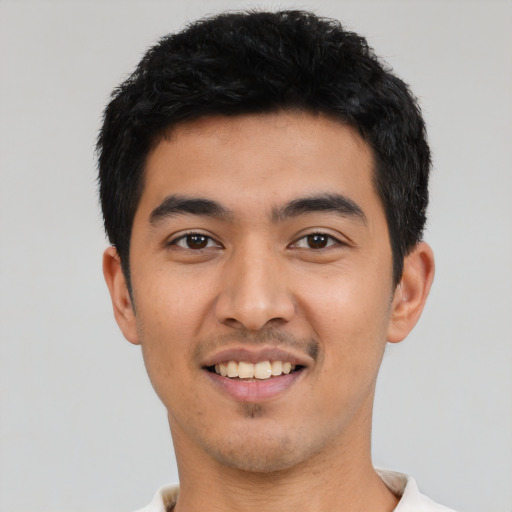 Joyful asian young-adult male with short  black hair and brown eyes