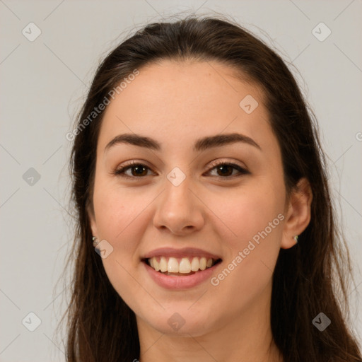 Joyful white young-adult female with long  brown hair and brown eyes