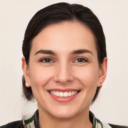 Joyful white young-adult female with medium  brown hair and brown eyes