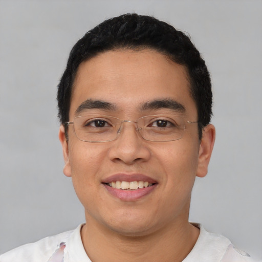 Joyful latino young-adult male with short  black hair and brown eyes