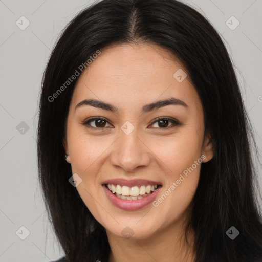 Joyful latino young-adult female with long  brown hair and brown eyes