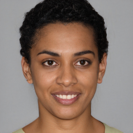 Joyful latino young-adult female with short  black hair and brown eyes