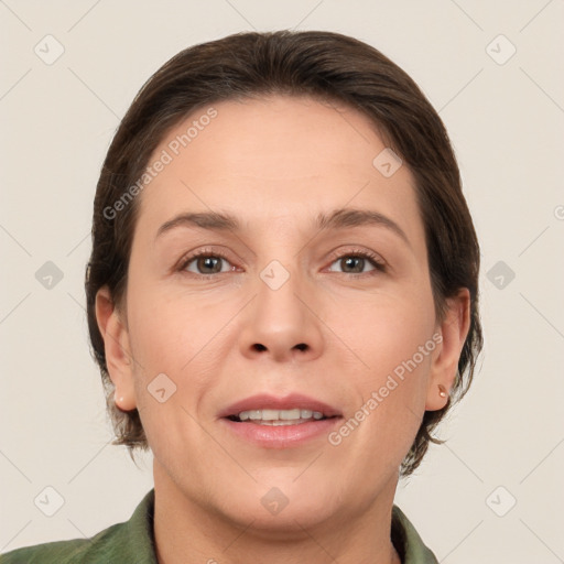 Joyful white adult female with medium  brown hair and brown eyes