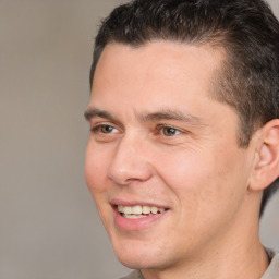 Joyful white adult male with short  brown hair and brown eyes