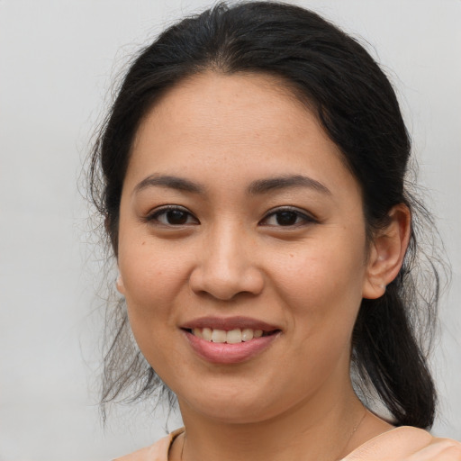 Joyful latino young-adult female with medium  brown hair and brown eyes