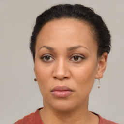 Joyful black adult female with short  brown hair and brown eyes