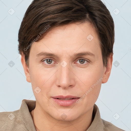 Joyful white young-adult female with short  brown hair and grey eyes