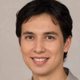 Joyful white young-adult male with medium  brown hair and brown eyes