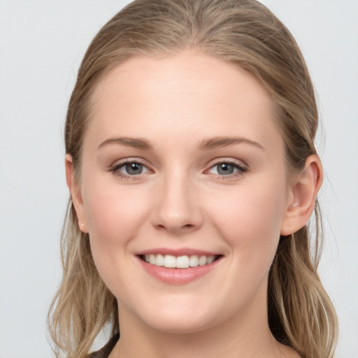 Joyful white young-adult female with long  brown hair and blue eyes