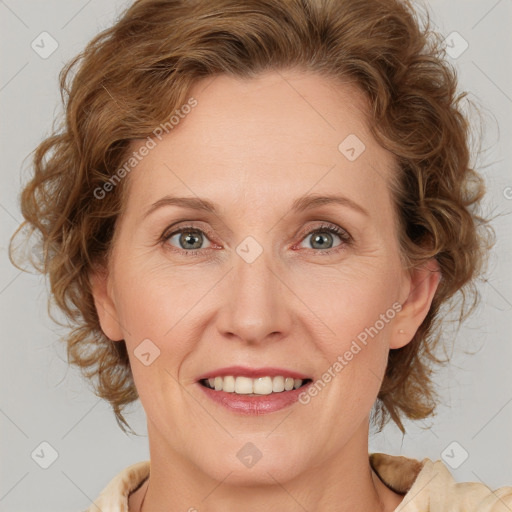 Joyful white adult female with medium  brown hair and blue eyes