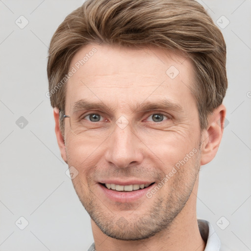 Joyful white adult male with short  brown hair and grey eyes