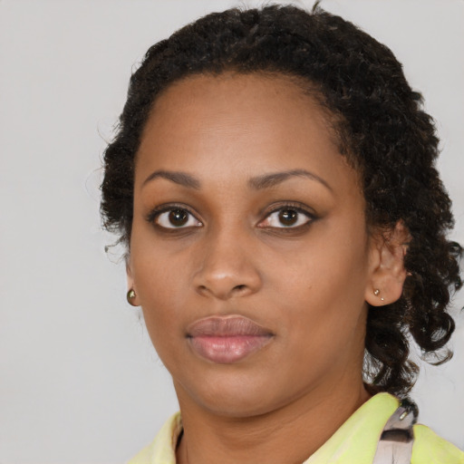 Neutral black young-adult female with medium  brown hair and brown eyes