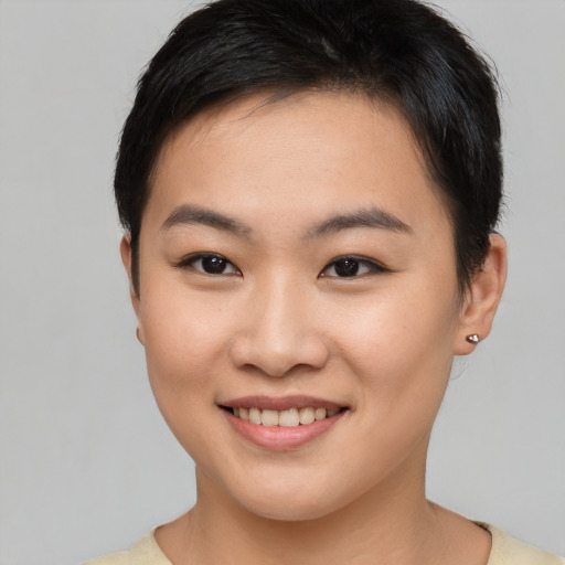 Joyful asian young-adult female with short  brown hair and brown eyes