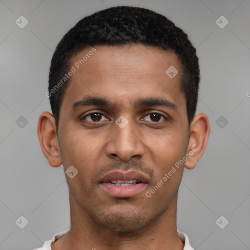 Joyful black young-adult male with short  brown hair and brown eyes