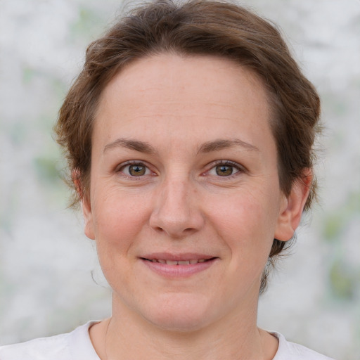 Joyful white adult female with short  brown hair and grey eyes