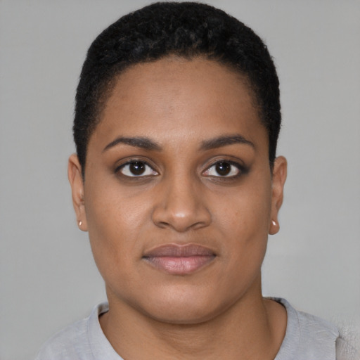 Joyful black young-adult female with short  brown hair and brown eyes
