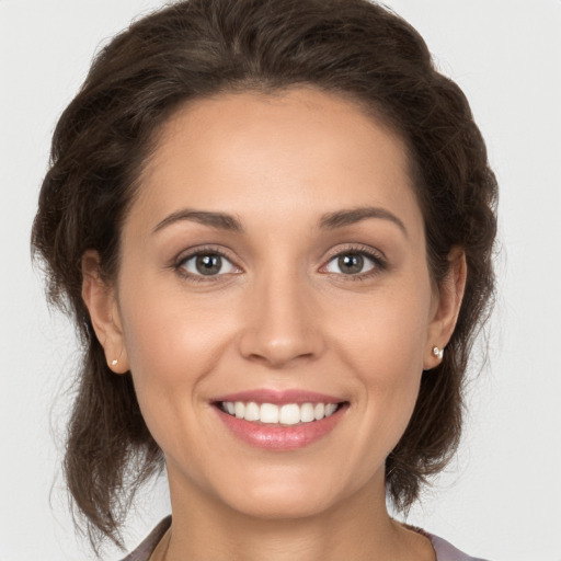 Joyful white young-adult female with medium  brown hair and brown eyes