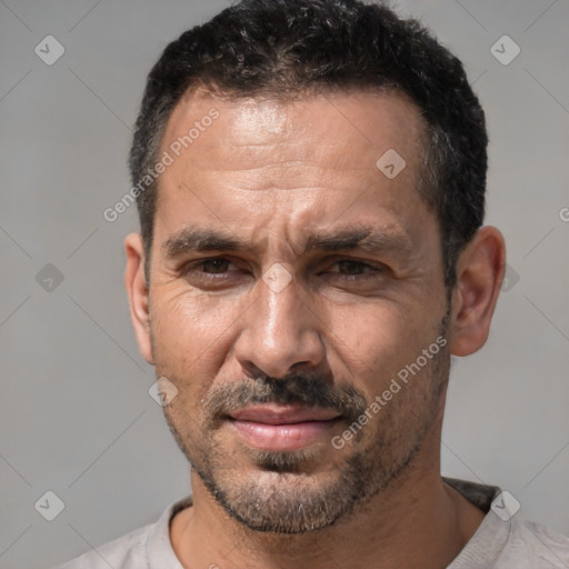 Joyful white adult male with short  black hair and brown eyes