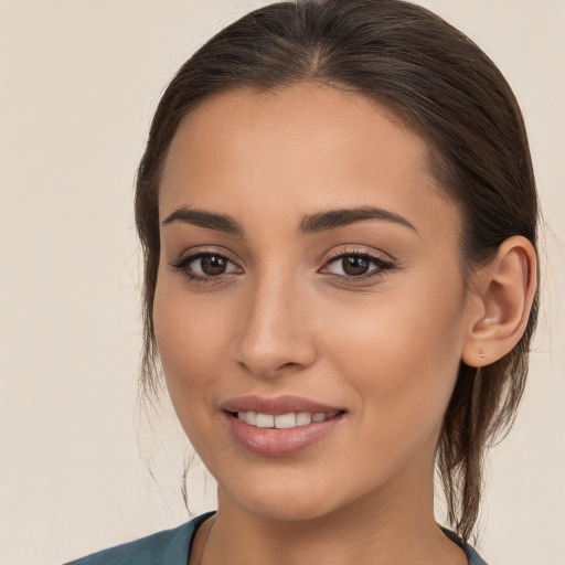 Joyful white young-adult female with long  brown hair and brown eyes