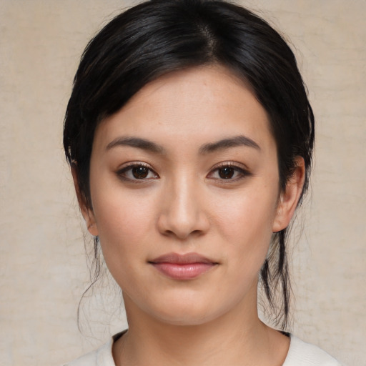 Joyful white young-adult female with medium  black hair and brown eyes