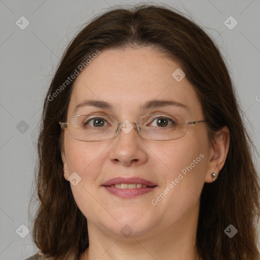 Joyful white adult female with long  brown hair and grey eyes