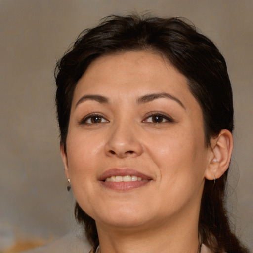 Joyful white adult female with medium  brown hair and brown eyes