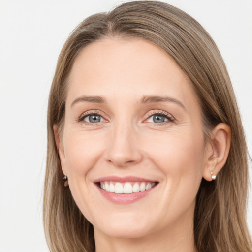 Joyful white young-adult female with long  brown hair and grey eyes