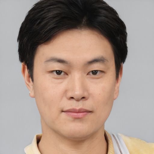 Neutral asian young-adult male with short  brown hair and brown eyes