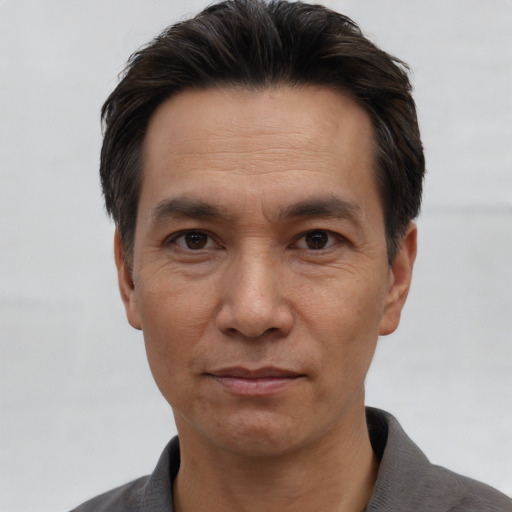 Joyful white adult male with short  black hair and brown eyes