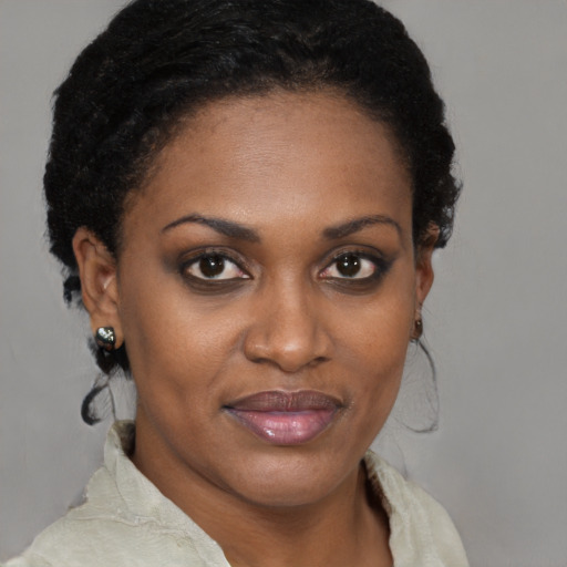 Joyful black young-adult female with short  brown hair and brown eyes