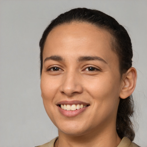 Joyful latino young-adult female with medium  brown hair and brown eyes