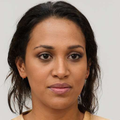 Joyful black young-adult female with medium  brown hair and brown eyes