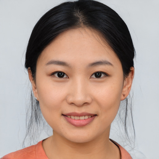 Joyful asian young-adult female with medium  black hair and brown eyes