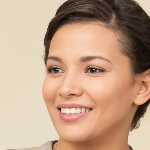 Joyful white young-adult female with medium  brown hair and brown eyes