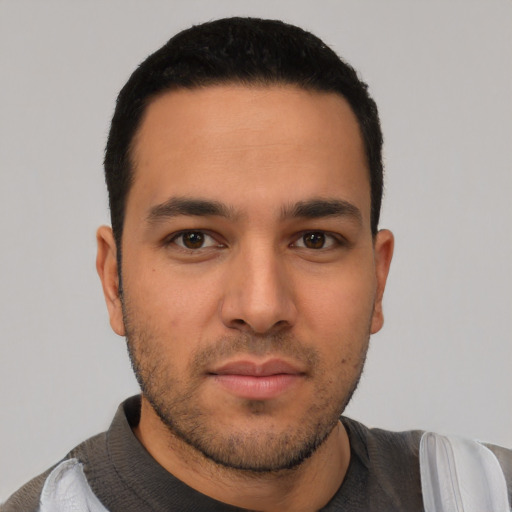 Neutral latino young-adult male with short  black hair and brown eyes