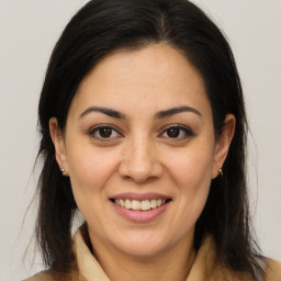 Joyful latino young-adult female with long  brown hair and brown eyes