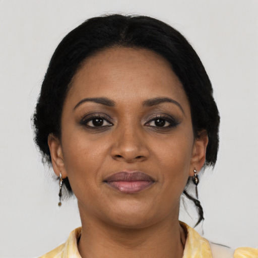 Joyful black young-adult female with medium  black hair and brown eyes