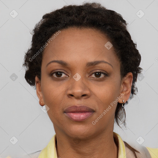 Joyful black adult female with short  brown hair and brown eyes