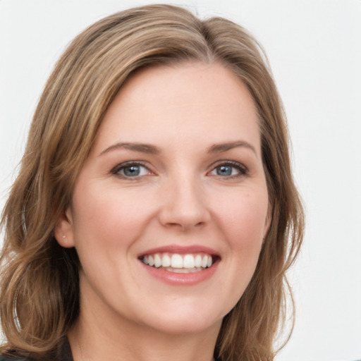 Joyful white young-adult female with medium  brown hair and green eyes